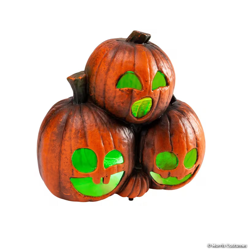 Three stacked jack-o-lanterns with glowing green eyes and mouths