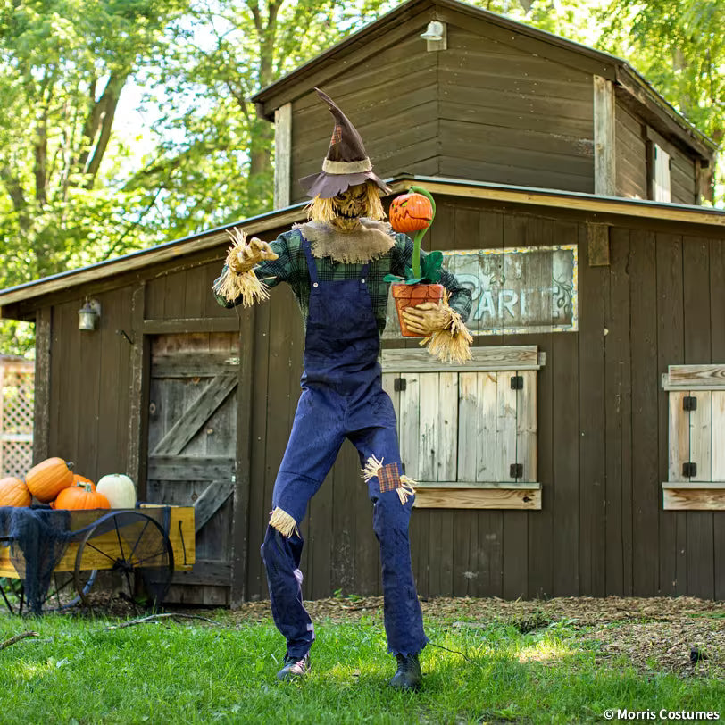 Seven-foot Rotten Harvester scarecrow animatronic with pumpkin companion, full display